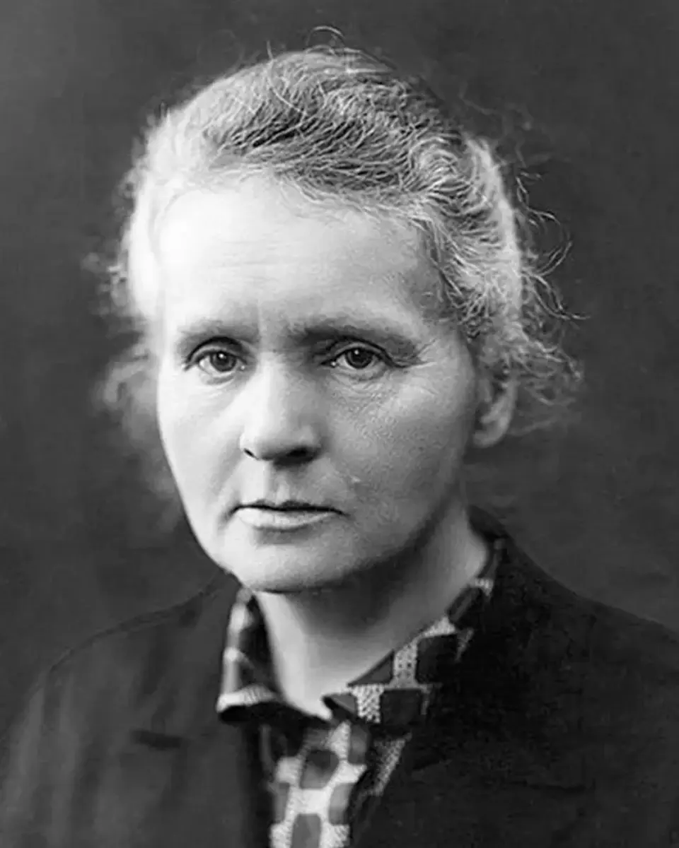 Black-and-white portrait of Marie Curie seated facing the camera.